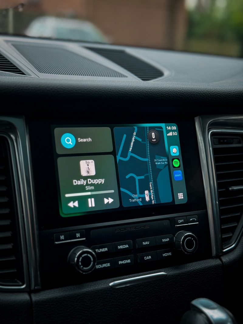 Apple CarPlay navigation and music running on a Porsche PCM4 screen