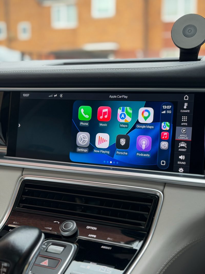 Before — Apple CarPlay confined to a half-screen window on a Porsche PCM4.1 display, home screen