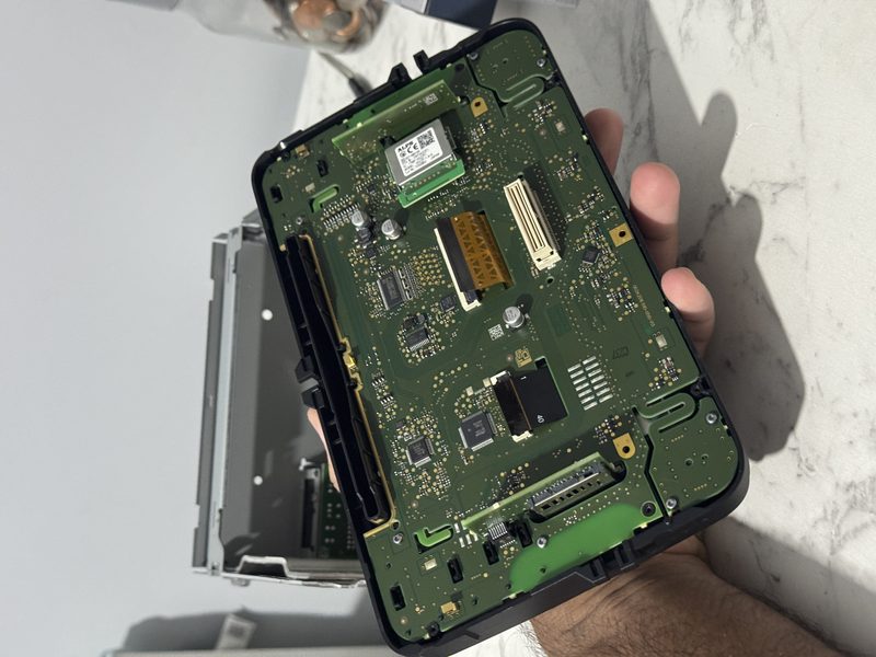 Head unit opened up for digitiser repair, showing the internal circuit board — VW/Skoda/SEAT Screen Digitiser Replacement Service on a Volkswagen